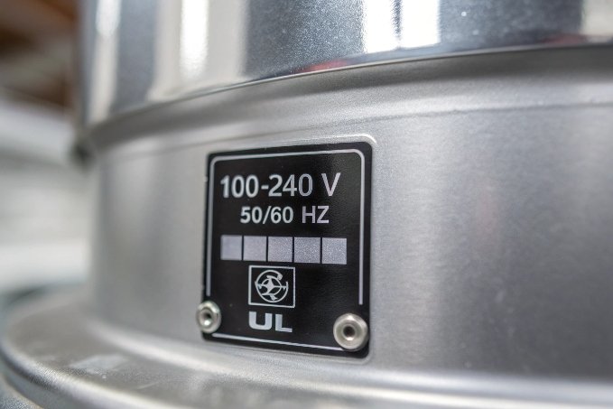 Close-up of UL voltage label on silver machine (ID#2)