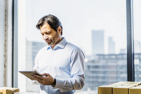 Man using tablet in office with city view (ID#1)