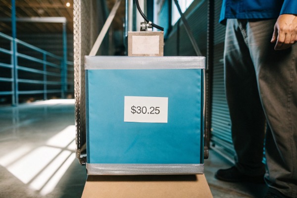 Blue box with price tag $30.25 in warehouse (ID#4)