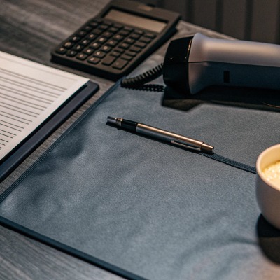 Desk with calculator, phone, pen, and coffee cup (ID#5)
