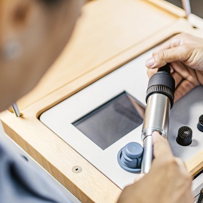 Hands adjusting settings on medical equipment (ID#4)