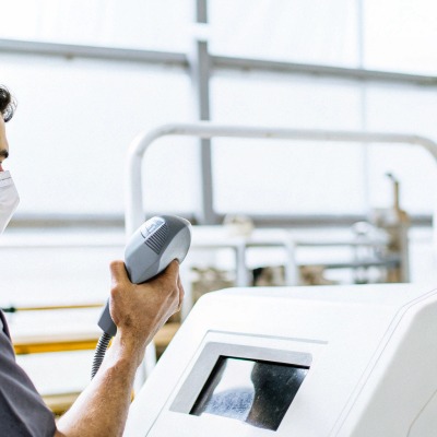 Operator using handheld laser device with screen (ID#5)